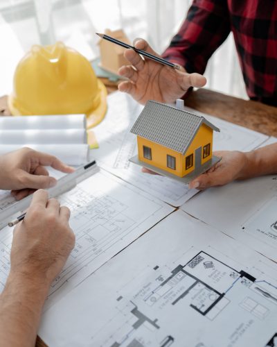 Design blueprints for use in structural work, Draw structural of buildings at the meeting and discuss together, engineer is in planning meeting with architect about building a house, architect idea.